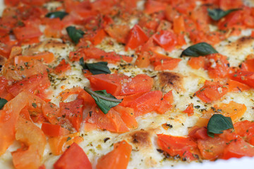 Italian pizza close up with fresh tomato, basil and mozzarella