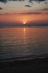Sunset on the beach with calm sea in the foreground. Koh Samui island in Thailand