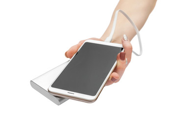 Woman's hands holding smartphone with powerbank. Isolated on white.
