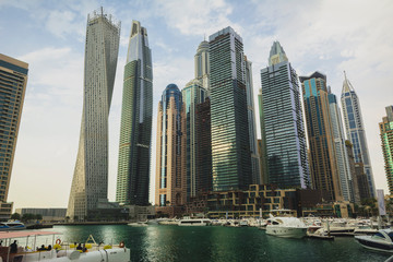 Fototapeta na wymiar Modern buildings in the Dubai Marina. Yachts. Luxury lifestyle in the United Arab Emirates.