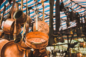Handcrafted bronze kitchen utensils at the ¨San Telmo¨market, Buenos Aires, Argentina. 
Hanging...