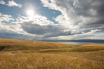 Obraz premium Lake Baikal. Beautiful autumn landscape of Lake Baikal with bright saturated sky, blue water.