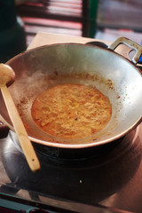 Cooking delicious traditional Thai red curry in cooking class. Chiang Mai Thailand