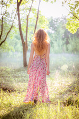 Plakat woman side portrait in forest with soft sun lights in outdoor