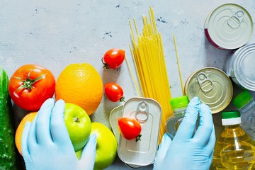 Food donation on a blue background. Food collection during a pandemic (epidemic), safe food delivery.