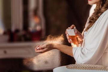 the beautiful bride uses perfume in the morning