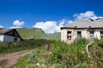 Fototapeta na wymiar Abandoned village overlooking Mount Elbrus. Old house and amazing nature