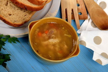 tasty tripe soup in a small bowl next to dry bread