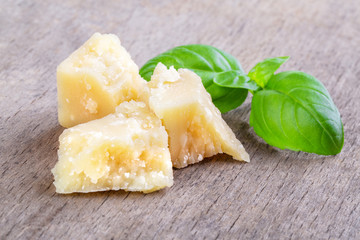 Pieces of parmesan cheese and a basil leaf