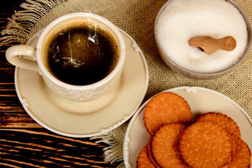 cookies next to a retro-style mug full of black coffee