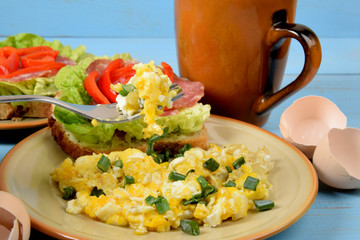 scrambled eggs with chives on a fork