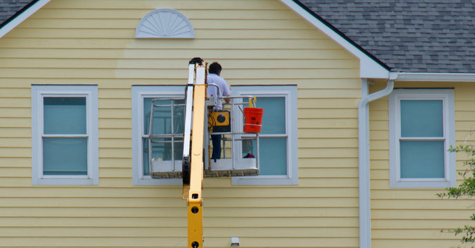 Worker Painting A House