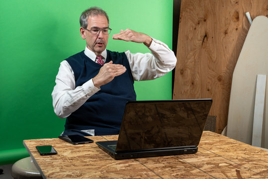 Man Working From Home In His Basement On A Virutal Meeting.