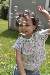 little girl playing with bubbles