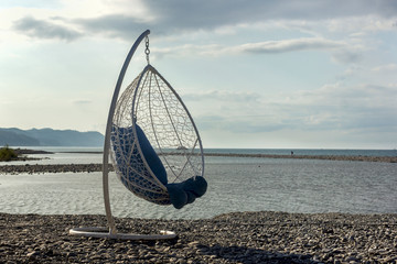morning hanging round chair hammock on the beach by the sea