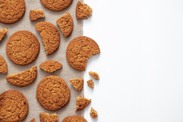 round oatmeal cookies, pieces and crumbs on a napkin, place for text, background or blank for home baking and cooking, for menus and recipes