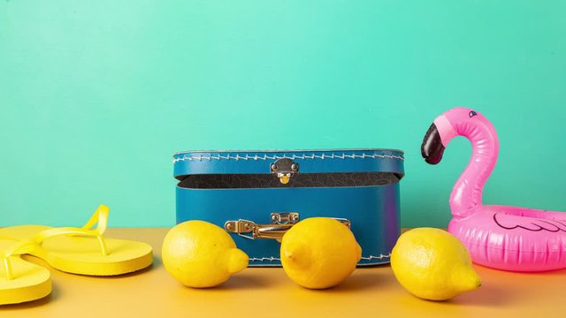 Stop motion animation of beach accessories and blue suitcase. Holiday planning, summer vacations concept