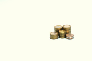 Piles of golden metallic coins. Columns of coins of different heights. The concept of business, economy, finance, investment and prices. Place for text and background for design.