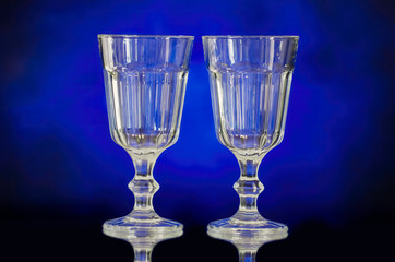 Empty glass or crystal wine glasses with blue background photography. 