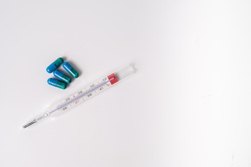 Obraz premium surgical mask medicinal capsules and thermometer