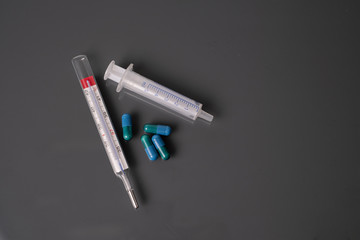 Obraz premium medicine thermometer and syringe background