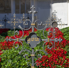 cemetery cross for wrought iron tomb engraved with beautiful red flowers with the next deceased: you