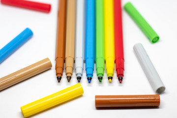 Multicolored felt-tip pens on a white background