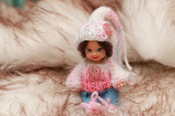 A small beautiful child's doll, posing in beautiful places.  Queen. 