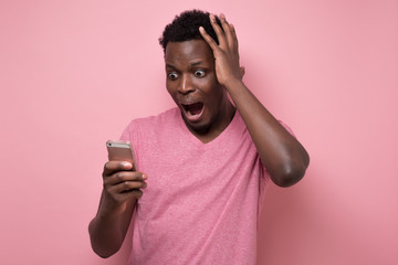 man yelling at mobile phone receiving news that he lost his money