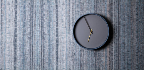 Stylish clock on a texture wall, minimalism design