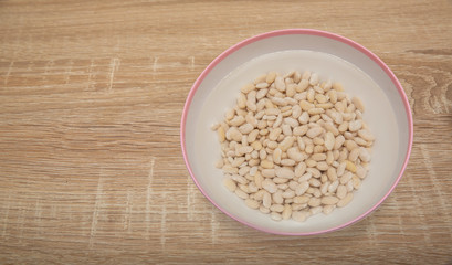 White beans  in water on isolated white background
