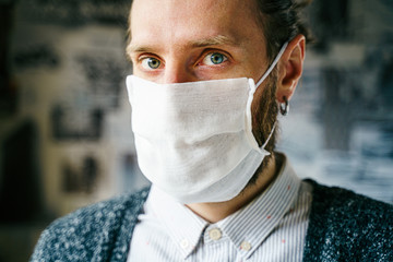 Portrait of a bearded man in a gauze mask. Preventive protection of your own health from viral infection. Coronavirus concept.