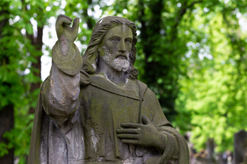 Historic Statue on the spring mystery old Prague Cemetery, Czech Republic