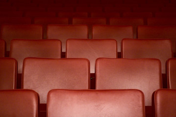 Fototapeta premium Empty red seats of a theater after the curfew regarding corona virus