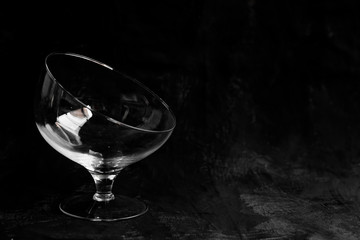 glass vase in the form of a cut glass of wine on a black background copy space