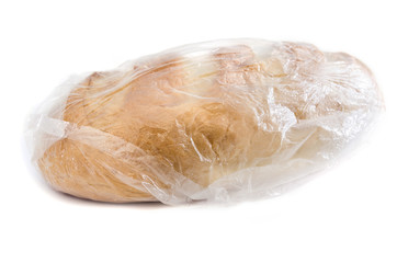 long loaf in plastic bag isolated on a white background.