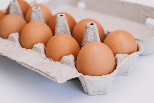 Ten eggs in carton box. Isolated on a white background.