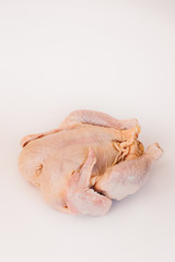 Uncooked chicken. Big and thick. Rests on the back. Isolated on a white background.