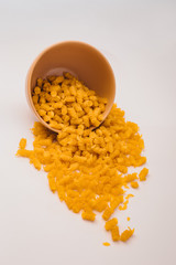 A small pile of gluten free corn pasta in plate on a white background. Gluten Free Pasta