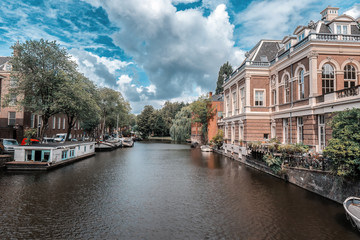 Fototapeta na wymiar Dutch waterway in Amsterdam with a view of houses and houseboats