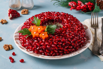 Salad Pomegranate bracelet on a blue background. Traditional Russian New Year's festive salad