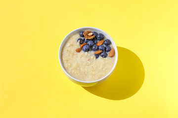 Oatmeal with berries and nuts. Diet breakfast. Food background