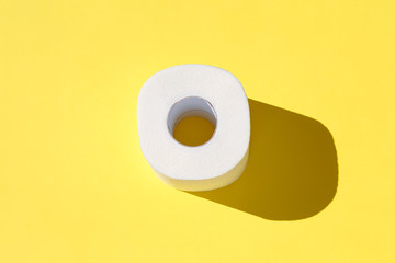 Toilet paper roll on a yellow background.