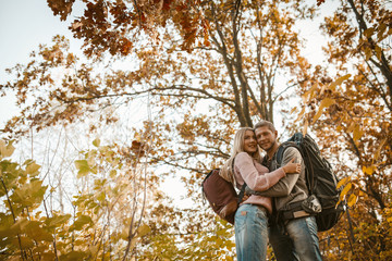 Man And Woman Hugs Standing In Autumn Forest