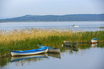 Fototapeta na wymiar Fishing boat in blue lake Golyazi Village of Turkey
