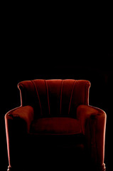 silhouette of red arm chair on black background