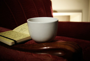 Relaxing coffee and book in quite arm chair