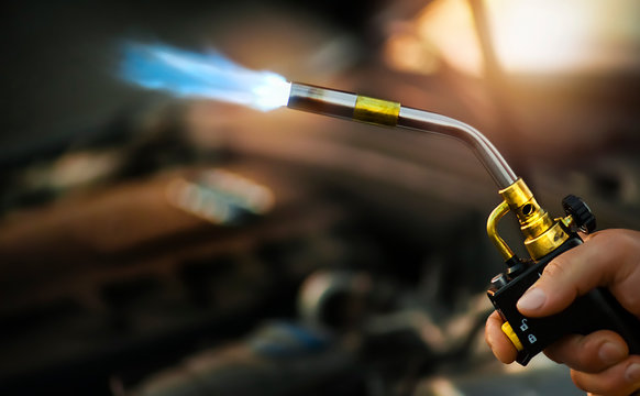 Gas torch burner in steel company. A flammable hydrocarbon gas burn  use water instaler or wood burning for grill food preparation - Powered by Adobe