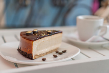 cup of coffee with piece chocolate cake