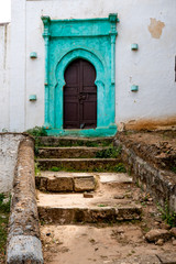 Fototapeta na wymiar Beautiful old arabic architecture on turquoise door in Morocco